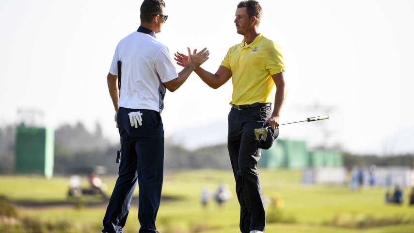 RIO DE JANEIRO, BRAZIL - AUGUST 14: Henrik Stenson (R) of Sweden congratulates Justin Rose of Great Britain as Rose celebrates winning in the final round of men's golf on Day 9 of the Rio 2016 Olympic Games at the Olympic Golf Course on August 14, 2016 in Rio de Janeiro, Brazil. (Photo by Ross Kinnaird/Getty Images)