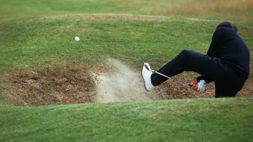 Spanish golfer Seve Ballesteros attempts an unusual bunker shot during practice for the Open Championship at the Royal Birkdale Golf Club, Southport, 1998. (Photo by Stephen Munday/Getty Images)