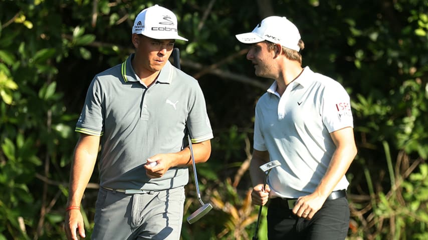 PLAYA DEL CARMEN, MEXICO - NOVEMBER 09: Rickie Fowler the United States and Emiliano Grillo of Argentina talk on the 16th green during the first round of the OHL Classic at Mayakoba on November 9, 2017 in Playa del Carmen, Mexico. (Photo by Rob Carr/Getty Images)