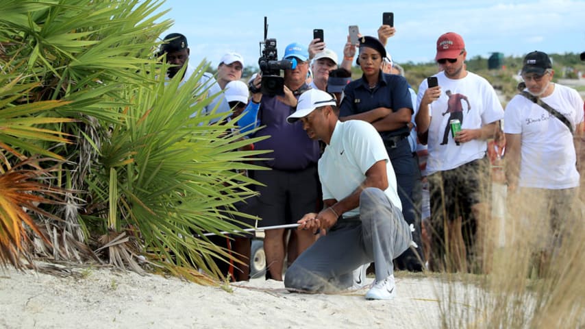 Woods avoids penalty after double-hit on final hole