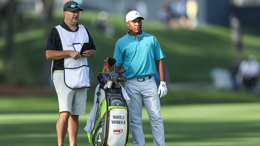 PONTE VEDRA BEACH, FLORIDA - MARCH 14: Harold Varner III of the United States waits to play his second shot on the par 4, 10th hole with his caddie Ray Farnell during the first round of the 2019 Players Championship held on the Stadium Course at TPC Sawgrass on March 14, 2019 in Ponte Vedra Beach, Florida. (Photo by David Cannon/Getty Images)