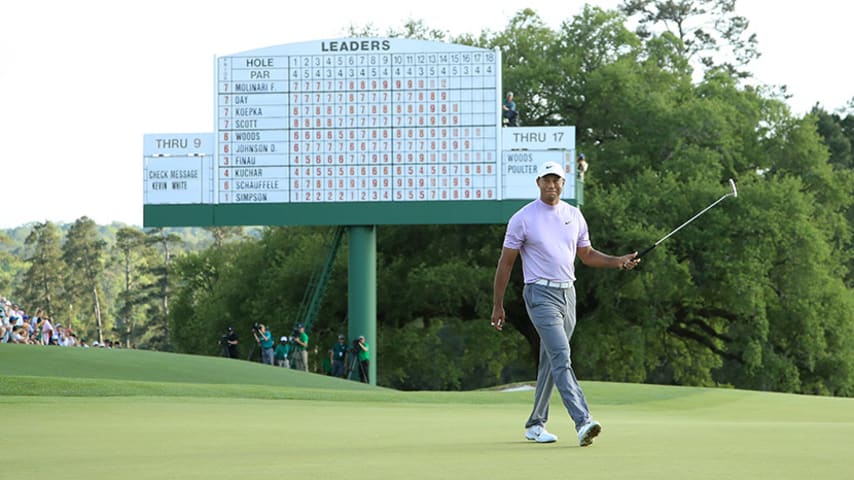 AUGUSTA, GEORGIA - APRIL 13: Tiger Woods of the United States acknowledges patrons after putting on the 18th green during the third round of the Masters at Augusta National Golf Club on April 13, 2019 in Augusta, Georgia. (Photo by Andrew Redington/Getty Images)