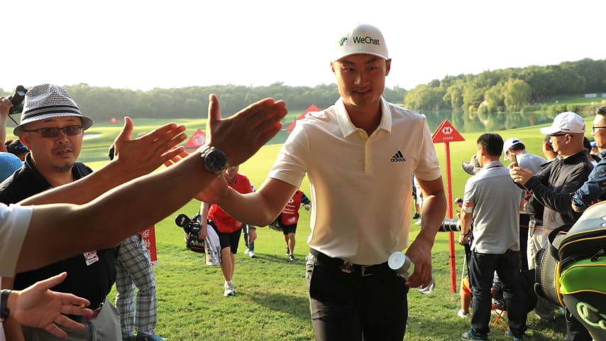 SHANGHAI, CHINA - OCTOBER 31:  Haotong Li of China walks off the 9th green after his round during Day one of the WGC HSBC Champions at Sheshan International golf club on October 31, 2019 in Shanghai, China. (Photo by Matthew Lewis/Getty Images)