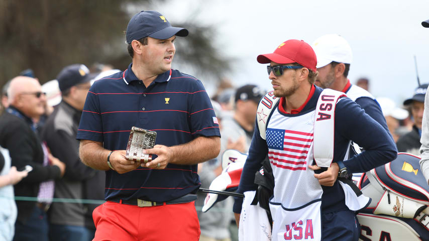 VICTORIA , AUSTRALIA - DECEMBER 14: U.S. Team's Patrick Reed walks with his caddie Kessler Karain during the third round of four-ball matches at the Presidents Cup at The Royal Melbourne Golf Club on December 14, 2019, in Victoria , Australia. (Photo by Mark Avellino/PGA TOUR via Getty Images)