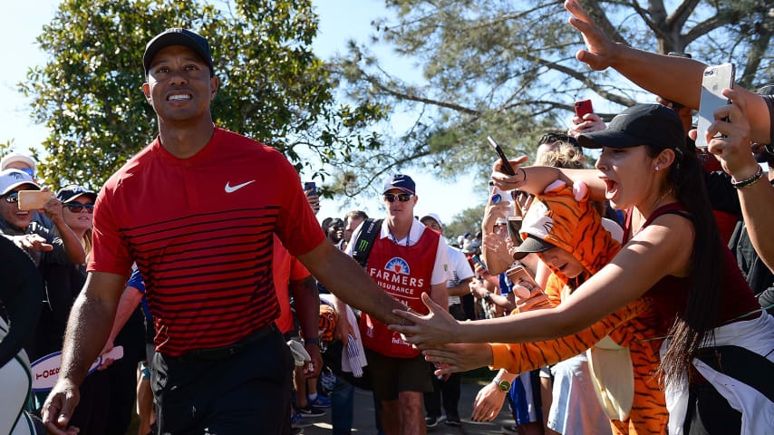 SAN DIEGO, CA - JANUARY 28:  Tiger Woods high fives a fan during the final round of the Farmers Insurance Open at Torrey Pines South  on January 28, 2018 in San Diego, California.  (Photo by Donald Miralle/Getty Images)