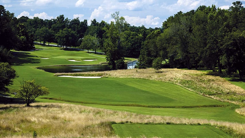 The downhill tee shot must avoid a small creek on the left and a large fairway bunker on the right. Going for the green in two will require a long carry over water and deep greenside bunkering to a severe back to front sloping green.