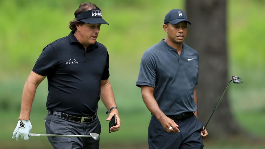 AKRON, OH - AUGUST 01:  Phil Mickelson (L) and Tiger Woods meet during a preview day of the World Golf Championships - Bridgestone Invitational at Firestone Country Club South Course at on August 1, 2018 in Akron, Ohio.  (Photo by Sam Greenwood/Getty Images)