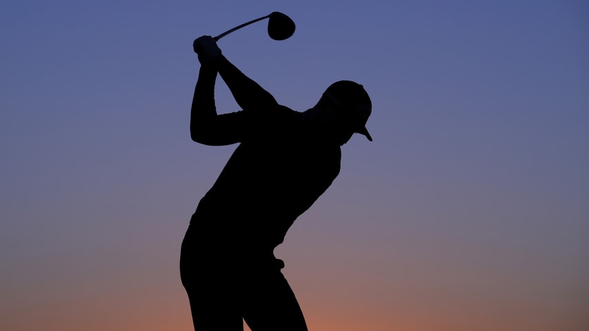 ABU DHABI, UNITED ARAB EMIRATES - JANUARY 16: A silhouette of Oliver Fisher of England as he practices on the range as the sun rises during Day One of the Abu Dhabi HSBC Championship at Abu Dhabi Golf Club on January 16, 2020 in Abu Dhabi, United Arab Emirates. (Photo by Warren Little/Getty Images)