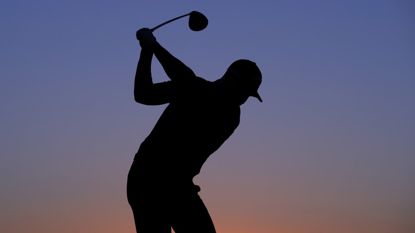 ABU DHABI, UNITED ARAB EMIRATES - JANUARY 16: A silhouette of Oliver Fisher of England as he practices on the range as the sun rises during Day One of the Abu Dhabi HSBC Championship at Abu Dhabi Golf Club on January 16, 2020 in Abu Dhabi, United Arab Emirates. (Photo by Warren Little/Getty Images)