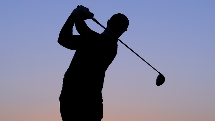 ABU DHABI, UNITED ARAB EMIRATES - JANUARY 16: A silhouette of Oliver Fisher of England as he practices on the range as the sun rises during Day One of the Abu Dhabi HSBC Championship at Abu Dhabi Golf Club on January 16, 2020 in Abu Dhabi, United Arab Emirates. (Photo by Warren Little/Getty Images)