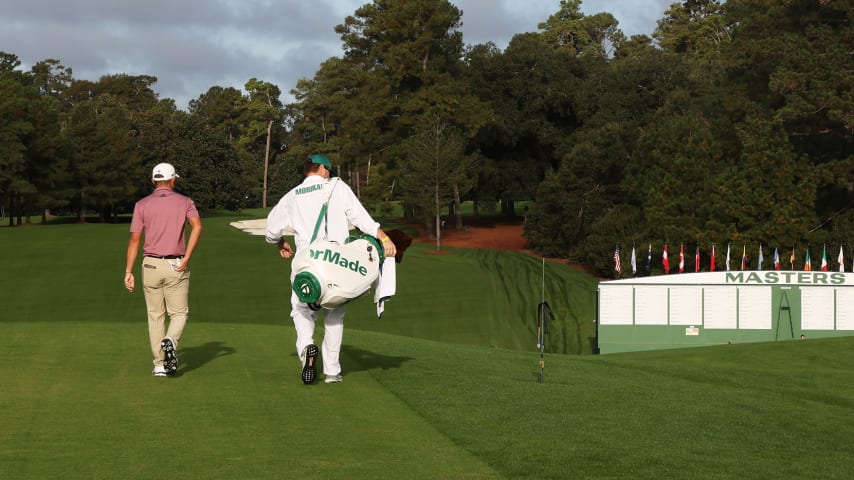 AUGUSTA, GEORGIA - NOVEMBER 09:  Collin Morikawa of the United States walks from the first tee with his caddie J.J. Jakovac during a practice round prior to the Masters at Augusta National Golf Club on November 09, 2020 in Augusta, Georgia. (Photo by Jamie Squire/Getty Images)