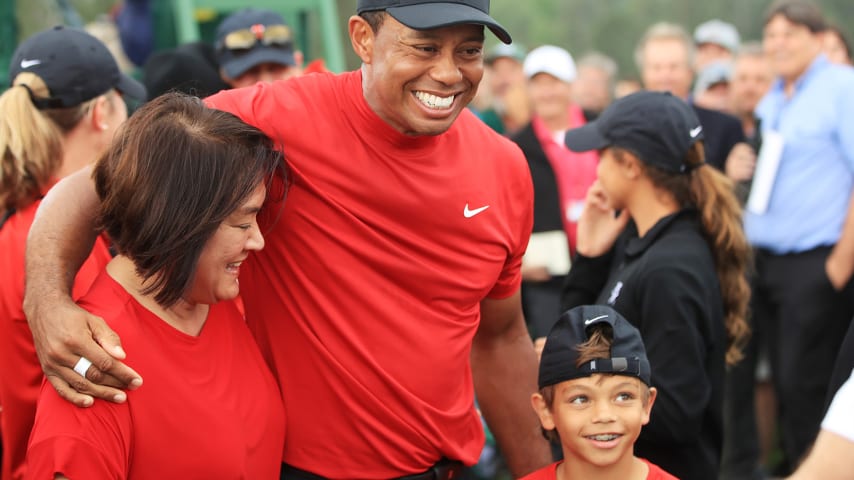 AUGUSTA, GEORGIA - APRIL 14: Tiger Woods of the United States  celebrates with his son Charlie Axel as he comes off the 18th hole in honor of his win during the final round of the Masters at Augusta National Golf Club on April 14, 2019 in Augusta, Georgia. (Photo by Andrew Redington/Getty Images)