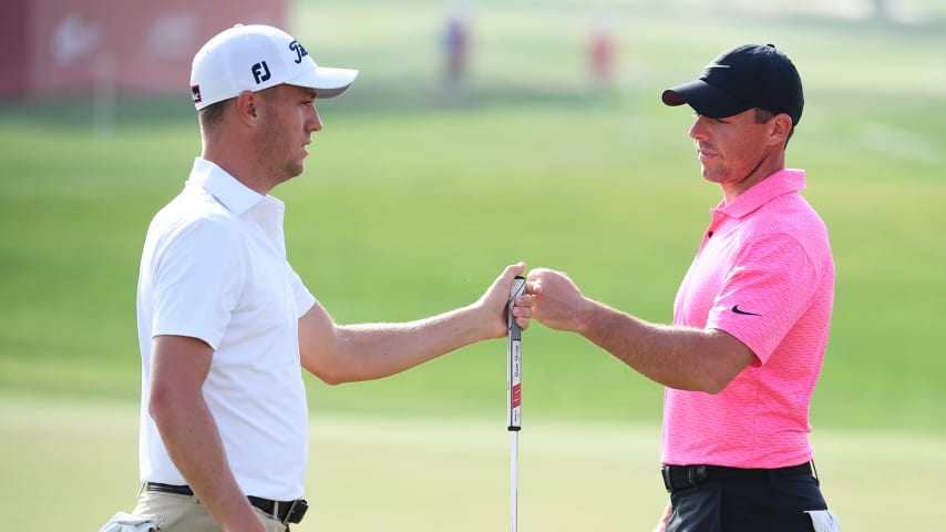 ABU DHABI, UNITED ARAB EMIRATES - JANUARY 21: Justin Thomas of the United States of America and Rory McIlroy of Northern Ireland fist bump on the 9th green during Day One of the Abu Dhabi HSBC Championship at Abu Dhabi Golf Club on January 21, 2021 in Abu Dhabi, United Arab Emirates. (Photo by Ross Kinnaird/Getty Images)