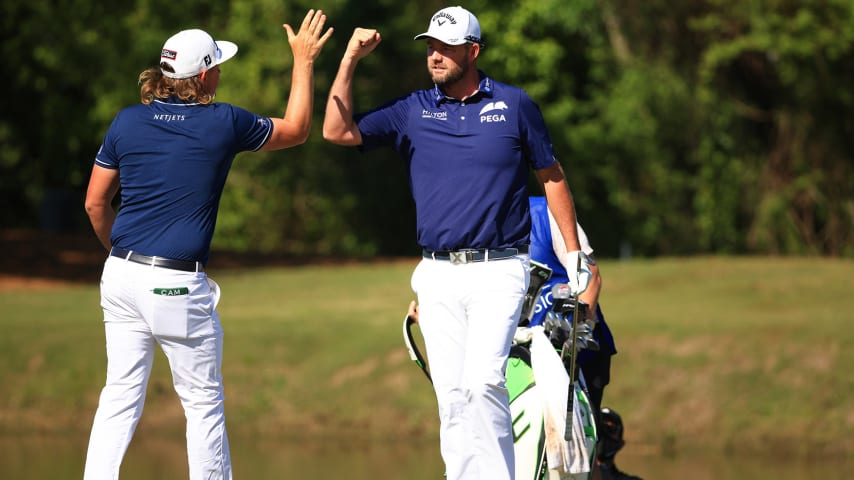 NEW ORLEANS, LOUISIANA - APRIL 25: Cameron Smith of Australia and Marc Leishman of Australia react to a birdie putt on the 16th green during the final round of the Zurich Classic of New Orleans at TPC Louisiana on April 25, 2021 in New Orleans, Louisiana. (Photo by Mike Ehrmann/Getty Images)