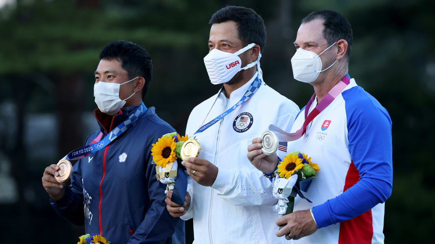 KAWAGOE, JAPAN - AUGUST 01: (L-R) C.T. Pan of Team Chinese Taipei celebrates with the bronze medal, Xander Schauffele of Team United States with the gold medal and Rory Sabbatini of Team Slovakia with the silver medal during the medal ceremony after the final round of the Men's Individual Stroke Play on day nine of the Tokyo 2020 Olympic Games at Kasumigaseki Country Club on August 01, 2021 in Kawagoe, Saitama, Japan. (Photo by Chris Trotman/Getty Images)