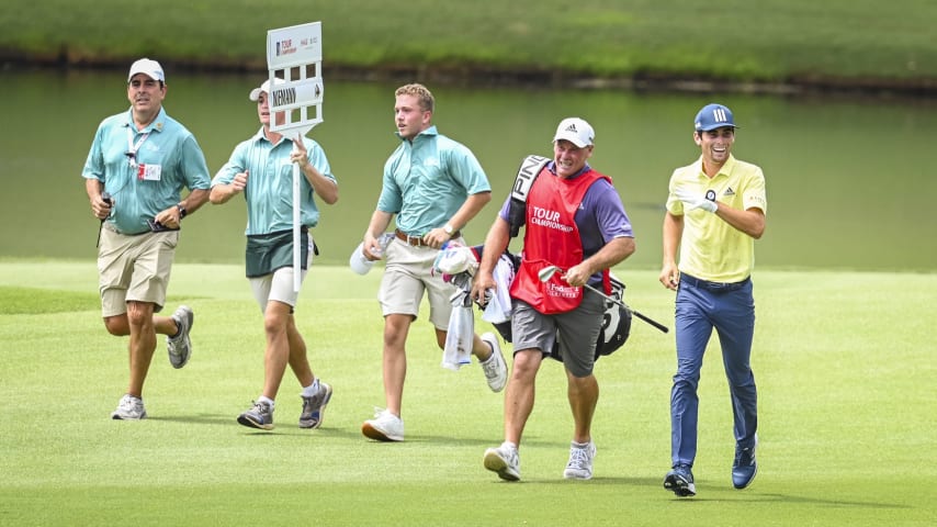 ATLANTA, GA - SEPTEMBER 05:  Joaquin Niemann of Chile smiles as he runs with his caddie Gary Matthews on the 18th hole, breaking the record for 18 holes played in 1 hour and 53 minutes, during the final round of the TOUR Championship, the final event of the FedExCup Playoffs, at East Lake Golf Club on September 5, 2021 in Atlanta, Georgia. (Photo by Keyur Khamar/PGA TOUR via Getty Images)