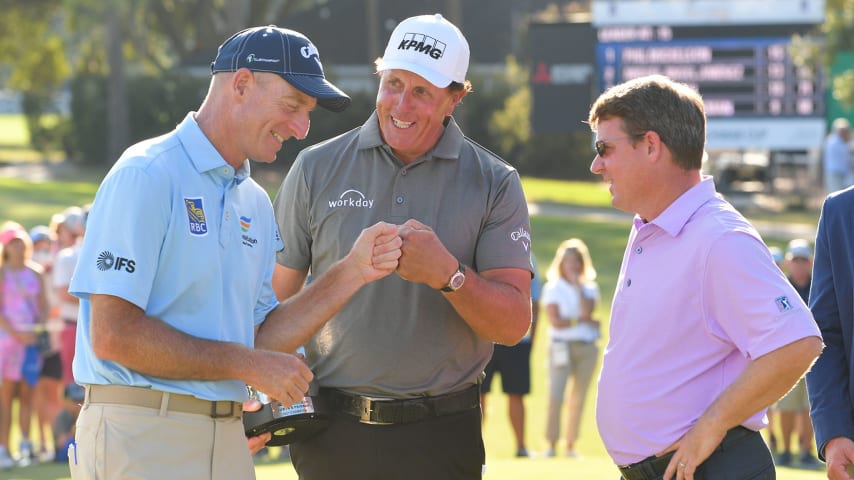 PONTE VEDRA BEACH - OCTOBER 10: Jim Furyk gives knuckles to Phil Mickelson on the 18th green after the final round of the PGA TOUR Champions Constellation FURYK & FRIENDS presented by Circle K at Timuquana Country Club on October 10, 2021 in Jacksonville, Florida. (Photo by Ben Jared/PGA TOUR via Getty Images)