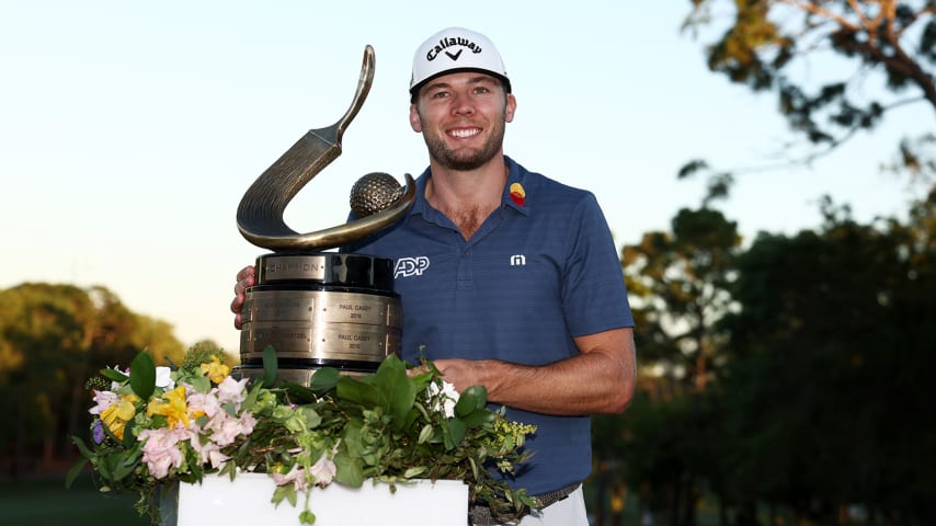 PALM HARBOR, FLORIDA - MARCH 20: Sam Burns of the United States celebrates with the trophy after winning during a playoff in the final round of the Valspar Championship on the Copperhead Course at Innisbrook Resort and Golf Club on March 20, 2022 in Palm Harbor, Florida. (Photo by Douglas P. DeFelice/Getty Images)