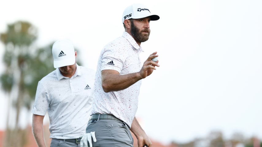 PONTE VEDRA BEACH, FLORIDA - MARCH 10: Dustin Johnson of the United States waves on the third green during the first round of THE PLAYERS Championship on the Stadium Course at TPC Sawgrass on March 10, 2022 in Ponte Vedra Beach, Florida. (Photo by Jared C. Tilton/Getty Images)