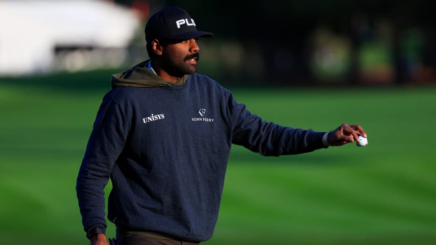 PONTE VEDRA BEACH, FLORIDA - MARCH 13: Sahith Theegala of the United States waves on the 16th green during the second round of THE PLAYERS Championship on the Stadium Course at TPC Sawgrass on March 13, 2022 in Ponte Vedra Beach, Florida. (Photo by Mike Ehrmann/Getty Images)