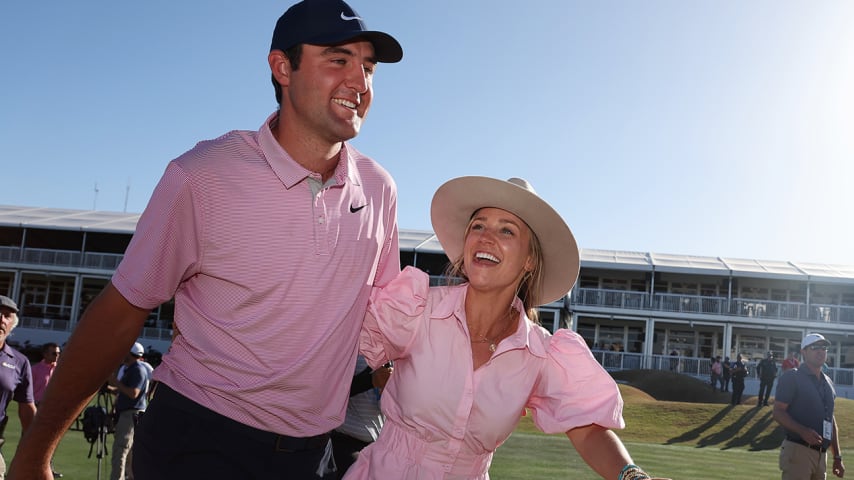 AUSTIN, TEXAS - MARCH 27: Scottie Scheffler of the United States celebrates with his wife Meredith Scheffler on the 15th green after defeating Kevin Kisner of the United States 4&3 in their finals match to win the World Golf Championships-Dell Technologies Match Play at Austin Country Club on March 27, 2022 in Austin, Texas. (Photo by Gregory Shamus/Getty Images)