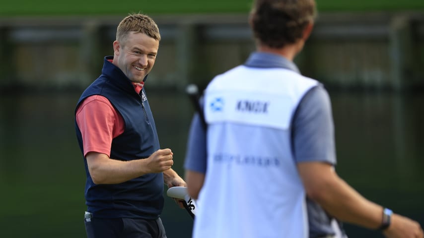 PONTE VEDRA BEACH, FLORIDA - MARCH 14: Russell Knox of Scotland reacts after making a putt on the 18th green during the final round of THE PLAYERS Championship on the Stadium Course at TPC Sawgrass on March 14, 2022 in Ponte Vedra Beach, Florida. (Photo by Mike Ehrmann/Getty Images)