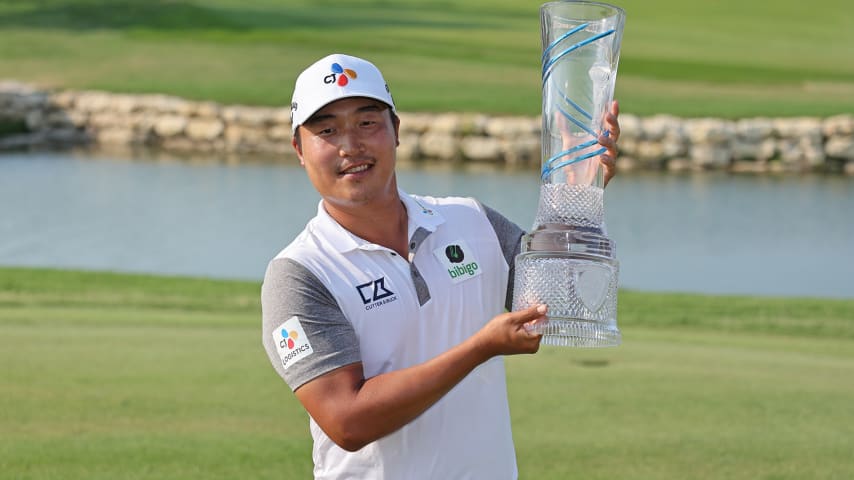 MCKINNEY, TEXAS - MAY 15: K.H. Lee of South Korea poses with the trophy after winning on the 18th green during the final round of the AT&T Byron Nelson at TPC Craig Ranch on May 15, 2022 in McKinney, Texas. (Photo by Gregory Shamus/Getty Images)