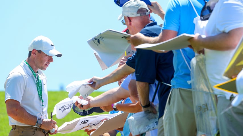 TULSA, OKLAHOMA - MAY 16: Rory McIlroy of Northern Ireland signs his autograph for fans during a practice round prior to the start of the 2022 PGA Championship at Southern Hills Country Club on May 16, 2022 in Tulsa, Oklahoma. (Photo by Andrew Redington/Getty Images)