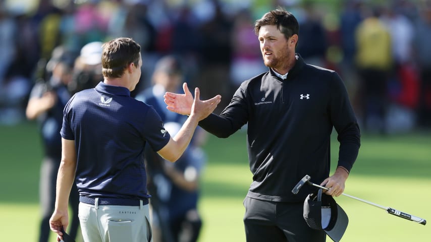 TULSA, OKLAHOMA - MAY 22: Mito Pereira of Chile hugs Matt Fitzpatrick of England as they finish their round on the 18th green during the final round of the 2022 PGA Championship at Southern Hills Country Club on May 22, 2022 in Tulsa, Oklahoma. (Photo by Richard Heathcote/Getty Images)