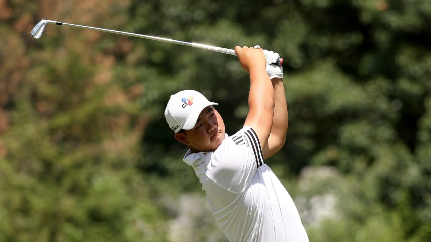 DETROIT, MICHIGAN - JULY 31: Joohyung Kim of South Korea plays his shot from the ninth tee during the final round of the Rocket Mortgage Classic at Detroit Golf Club on July 31, 2022 in Detroit, Michigan. (Photo by Mike Mulholland/Getty Images)