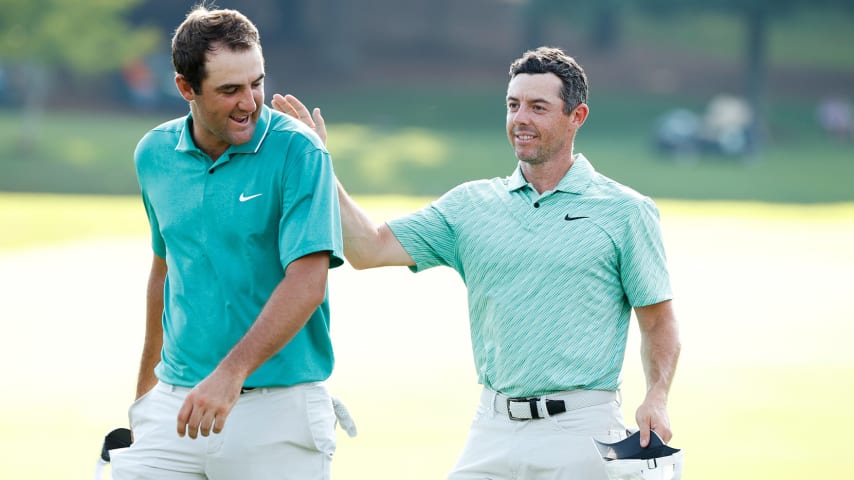 ATLANTA, GEORGIA - AUGUST 28: Scottie Scheffler of the United States congratulates Rory McIlroy of Northern Ireland on the 18th green after McIlroy won during the final round of the TOUR Championship at East Lake Golf Club on August 28, 2022 in Atlanta, Georgia. (Photo by Cliff Hawkins/Getty Images)