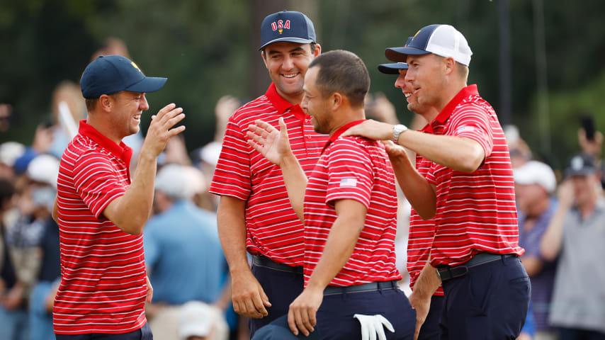 CHARLOTTE, NORTH CAROLINA - SEPTEMBER 25: Justin Thomas (L), Scottie Scheffler (2nd L), Sam Burns (2nd R) and Jordan Spieth (R) of the United States Team congratulate teammate Xander Schauffele (C) after his 1 Up win against Corey Conners of Canada and the International Team to clinch victory for the United States Team during Sunday singles matches on day four of the 2022 Presidents Cup at Quail Hollow Country Club on September 25, 2022 in Charlotte, North Carolina. (Photo by Jared C. Tilton/Getty Images)