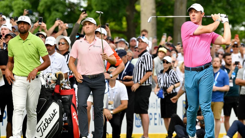 ETOBICOKE, ONTARIO - JUNE 12: Rory McIlroy of Northern Ireland plays his shot from the 16th tee as Tony Finau of the United States and Justin Thomas of the United States look on during the final round of the RBC Canadian Open at St. George's Golf and Country Club on June 12, 2022 in Etobicoke, Ontario. (Photo by Minas Panagiotakis/Getty Images)