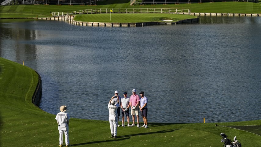 A caddie takes a photo of a foursome on the 17th tee on the Stadium Course at TPC Sawgrass, home of THE PLAYERS Championship, on January 20, 2023 in Ponte Vedra Beach, Florida. (Photo by Keyur Khamar/PGA TOUR via Getty Images)