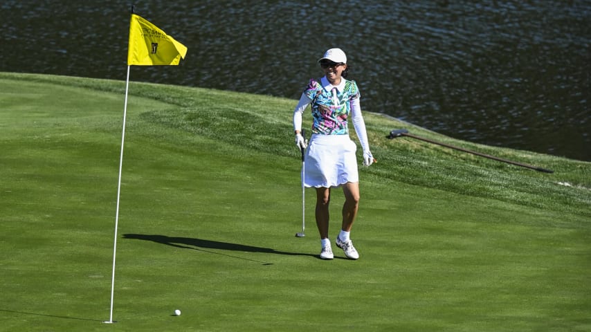 A golfer smiles before tapping in for par on the 17th hole on the Stadium Course at TPC Sawgrass, home of THE PLAYERS Championship, on January 20, 2023 in Ponte Vedra Beach, Florida. (Photo by Keyur Khamar/PGA TOUR via Getty Images)