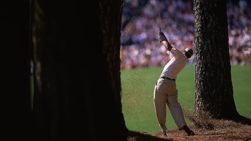 7 Apr 2000:  Tiger Woods of the USA cuts one from behind a tree on the second day of the US Masters at Augusta National GC in Georgia, USA. \ Mandatory Credit: Craig Jones /Allsport