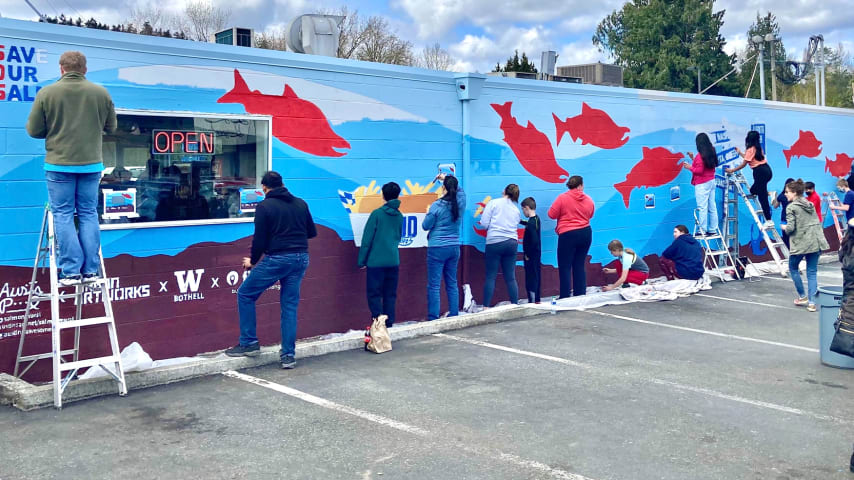 Volunteers help paint the “Save Our Salmon” (SOS) Mural. (Courtesy Austin Picinich)