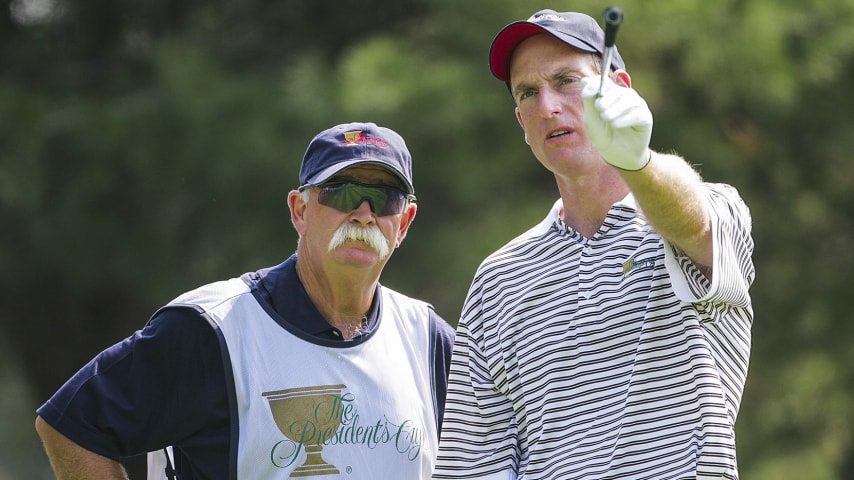 GAINESVILLE, VA - SEPTEMBER 23:  Jim Furyk of the USA chats with his caddie Mike Cowan on the second hole during the Friday Four-Ball Matches at the 2005 Presidents Cup on September 23, 2005 at Robert Trent Jones Golf Club in Gainesville, Virginia.  (Photo by Jamie Squire/Getty Images)