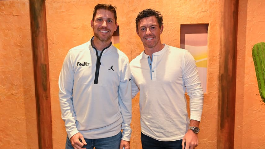 NASCAR driver, Denny Hamlin, a FedEx Ambassador, left, poses with FedExCup champion, Rory McIlroy of Northern Ireland, at an event as the PGA TOUR Celebrates 50 Years of FedEx at Puttery on May 2, 2023 in Charlotte, North Carolina. (Ben Jared/PGA TOUR)