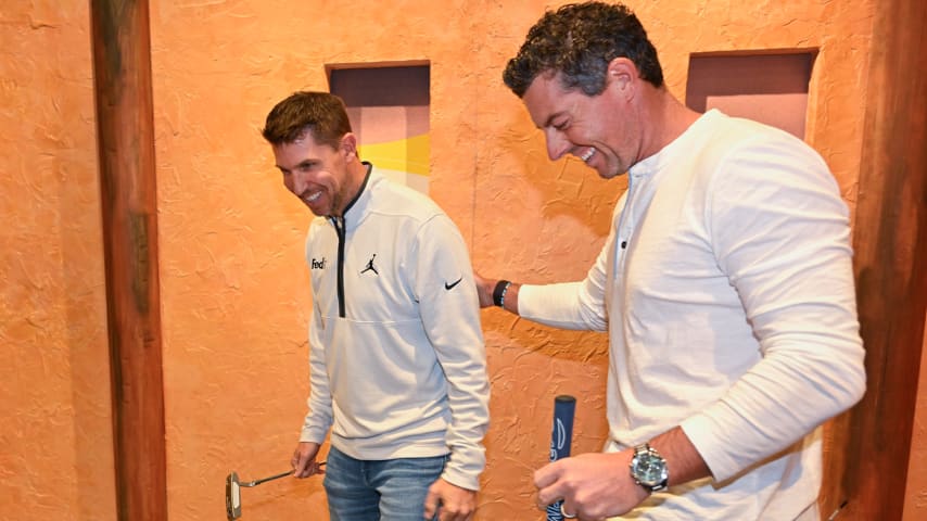 NASCAR driver, Denny Hamlin, a FedEx Ambassador, left, shares a laugh with FedExCup champion, Rory McIlroy, at an event as the PGA TOUR Celebrates 50 Years of FedEx at Puttery on May 2, 2023 in Charlotte, North Carolina. (Ben Jared/PGA TOUR)