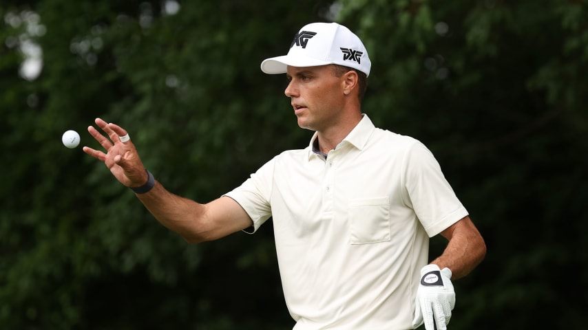 CROMWELL, CONNECTICUT - JUNE 24: Eric Cole of the United States catches a golf ball before hitting his shot from the 12th tee during the third round of the Travelers Championship at TPC River Highlands on June 24, 2023 in Cromwell, Connecticut. (Photo by Patrick Smith/Getty Images)