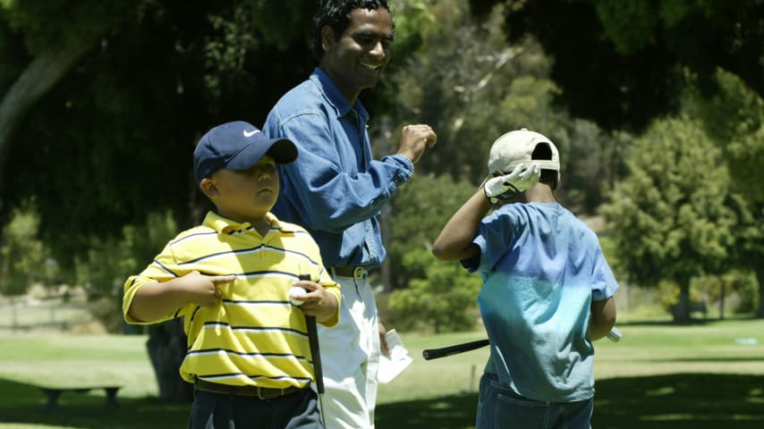 A young Sahith Theegala (right, with back to camera) with his father, Muralidhar Theegala. (Courtesy of Theegala family)