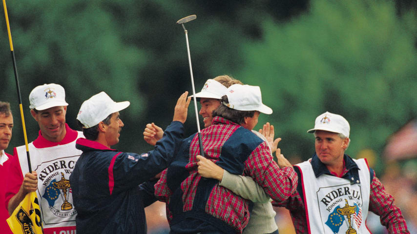 Davis Love III of the USA team is surrounded by his teammates on the 18th green after defeating European Costantino Rocca in the 1993 Ryder Cup. (David Cannon/Getty Images)