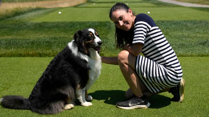 Lara Arias, golf course superintendent at Marco Simone, poses for a photo with her Australian Shepard "Ryder" during an interview with the Associated Press. (AP Photo/Alessandra Tarantino)