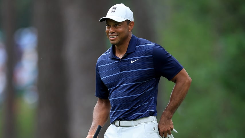 Tiger Woods seen on golf course hitting shots while hosting namesake junior event