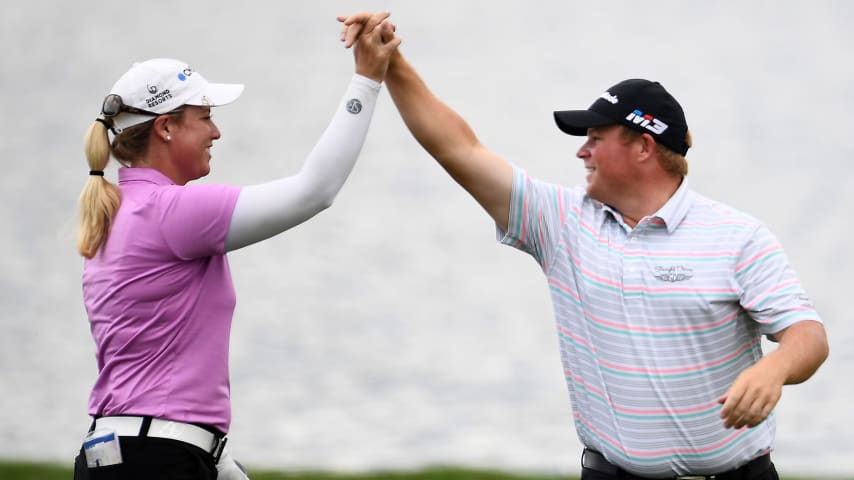 Brittany Lincicome is congratulated by Conrad Shindler after holing out for eagle in the 17th fairway during the second round of the 2018 Barbasol Championship. (Stacy Revere/Getty Images)