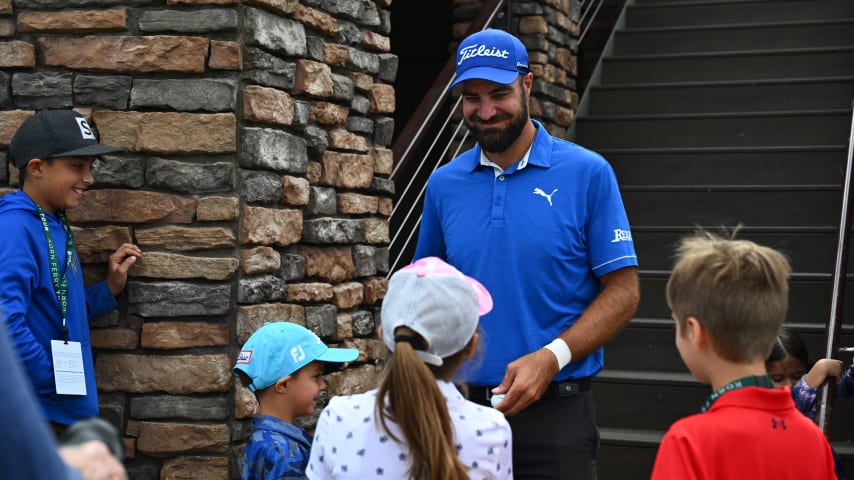 NEWBURGH, INDIANA - OCTOBER 08: Tom Whitney signs golf balls for his kids outside the clubhouse during the final round of the Korn Ferry Tour Championship presented by United Leasing and Financing at Victoria National Golf Club on October 8, 2023 in Newburgh, Indiana. (Photo by Jennifer Perez/PGA TOUR)