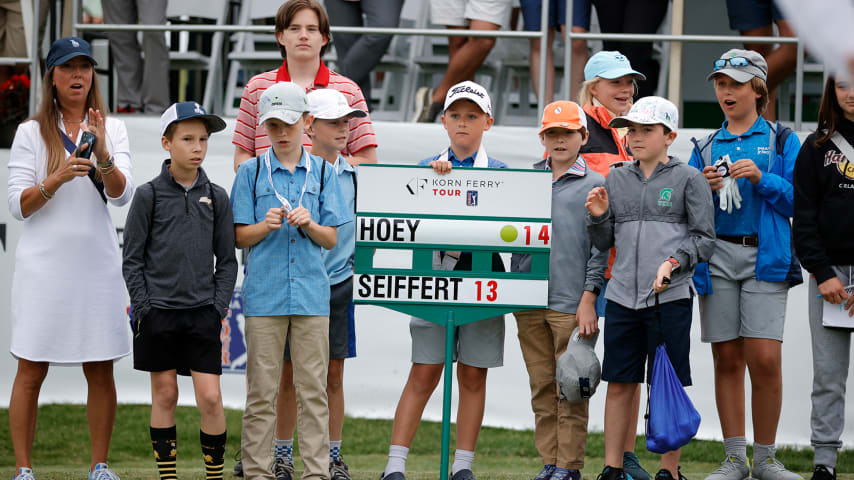 Children with the Boys & Girls Clubs of the Tennessee Valley stand with a scoring sign near the 18th green during the final round of the Visit Knoxville Open at Holston Hills Country Club. (Alex Slitz/Getty Images)