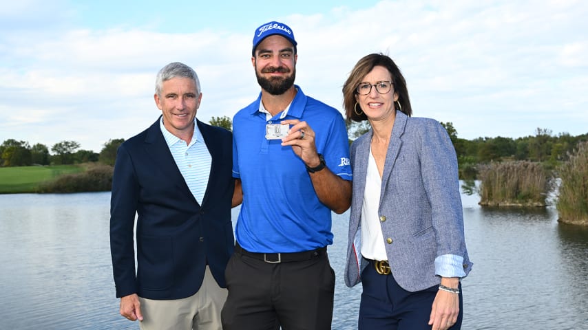 NEWBURGH, INDIANA - OCTOBER 08: Tom Whitney holds up his TOUR Card while posing for a photo with Commissioner Jay Monahan and President of the Korn Ferry Tour Alex Baldwin during the card ceremony after the final round of the Korn Ferry Tour Championship presented by United Leasing and Financing at Victoria National Golf Club on October 8, 2023 in Newburgh, Indiana. (Photo by Jennifer Perez/PGA TOUR)