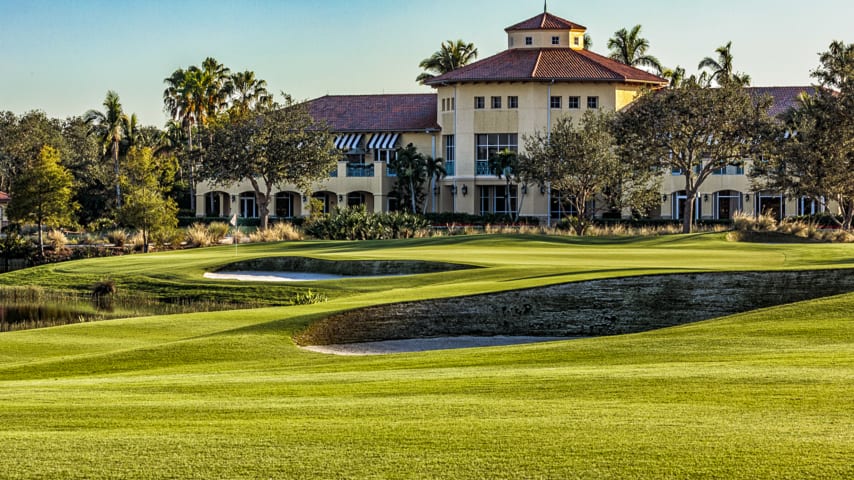 A photogenic closing hole with water on the left and a deep-faced fairway bunker on the right. A drive down the center of the fairway leaves a second shot slightly over water to a green surrounded by bunkers. 